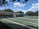 Well-manicured shuffleboard courts surrounded by a covered sitting area, perfect for leisure and social activities at 27141 Racquet Cir, Leesburg, FL 34748