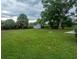 Private backyard with mature trees and a storage shed, offering space and tranquility at 2961 Northland Rd, Mount Dora, FL 32757