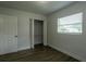 A bedroom with light walls, a built in closet and a window at 2961 Northland Rd, Mount Dora, FL 32757