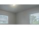 Bright bedroom features neutral walls and two windows that let in natural light at 2961 Northland Rd, Mount Dora, FL 32757