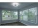 A bright room with wood floors and an expansive window overlooking the yard at 2961 Northland Rd, Mount Dora, FL 32757