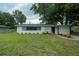 Charming single-story home featuring a well-maintained lawn and freshly painted exterior with dark trim at 2961 Northland Rd, Mount Dora, FL 32757