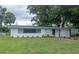 Charming single-story home featuring a well-manicured lawn, fresh exterior paint, and complemented by mature trees at 2961 Northland Rd, Mount Dora, FL 32757