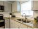 Updated kitchen featuring granite countertops, stainless steel appliances, and modern gray cabinetry at 2961 Northland Rd, Mount Dora, FL 32757