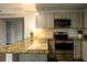 Beautiful kitchen boasts stainless appliances, granite counters and gray cabinets at 2961 Northland Rd, Mount Dora, FL 32757