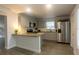 Bright kitchen featuring stainless steel appliances, granite counters, tile backsplash, and wood-look floors at 2961 Northland Rd, Mount Dora, FL 32757