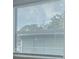 The window is shut with white binds and lets in lots of light at 2961 Northland Rd, Mount Dora, FL 32757