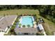 Aerial view of a community pool with ample lounge seating and lush landscaping at 30422 Pintail Dr, Leesburg, FL 34748