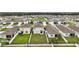 Aerial view of a neighborhood with well-maintained homes and green lawns at 30422 Pintail Dr, Leesburg, FL 34748