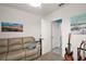 Carpeted bonus room with sofa and artwork, offering a flexible space for various activities at 30422 Pintail Dr, Leesburg, FL 34748