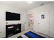 Comfortable bedroom featuring a TV, closet and doorway to another room, providing space for relaxation and entertainment at 30422 Pintail Dr, Leesburg, FL 34748
