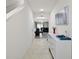 Bright entryway with white dresser, tile floors, and view to dining room at 30422 Pintail Dr, Leesburg, FL 34748
