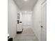 Bright entryway with white dresser, tile floors, and view to the front door and staircase at 30422 Pintail Dr, Leesburg, FL 34748