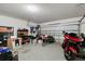 Spacious garage with epoxy floor and ample storage, providing a functional space for parking and hobbies at 30422 Pintail Dr, Leesburg, FL 34748