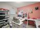 Bright home office with pink walls, built-in desk, and ample storage for creative projects at 30422 Pintail Dr, Leesburg, FL 34748