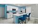 Bright kitchen with white cabinets, breakfast bar, stainless appliances, and island sink at 30422 Pintail Dr, Leesburg, FL 34748