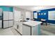 Bright kitchen with white cabinets, a breakfast bar with barstools, stainless appliances and an island sink at 30422 Pintail Dr, Leesburg, FL 34748