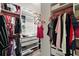 Organized walk-in closet featuring custom shelving, drawers, and hanging rods for efficient storage and a window for natural light at 30422 Pintail Dr, Leesburg, FL 34748