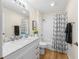 Bright bathroom with shower, vanity, hardwood floors, and white cabinets at 3057 Saint Thomas Ln, The Villages, FL 32162