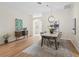 Bright dining area with open floor plan, modern lighting, and hardwood floors, perfect for entertaining at 3057 Saint Thomas Ln, The Villages, FL 32162