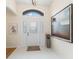 Bright foyer with tile flooring, white door, and a decorative painting adding a touch of elegance at 3057 Saint Thomas Ln, The Villages, FL 32162