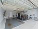 Spacious garage featuring coated floors, ample lighting, and room for multiple vehicles and storage at 3057 Saint Thomas Ln, The Villages, FL 32162