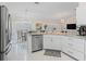 Bright eat-in kitchen with stainless steel appliances, granite countertops and modern cabinetry at 3057 Saint Thomas Ln, The Villages, FL 32162