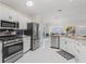 Modern kitchen featuring stainless steel appliances, granite countertops, and a view of the breakfast nook at 3057 Saint Thomas Ln, The Villages, FL 32162