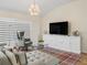 Cozy living room with stylish decor, ample seating, and a large TV for relaxation and entertainment at 3057 Saint Thomas Ln, The Villages, FL 32162