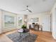 Inviting living room featuring hardwood floors, a ceiling fan, and lots of natural light at 3057 Saint Thomas Ln, The Villages, FL 32162
