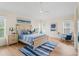 Serene main bedroom with a wooden bed frame, a ceiling fan, and natural light from multiple windows at 3057 Saint Thomas Ln, The Villages, FL 32162
