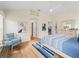 Bright main bedroom with hardwood floors, blue accents, and ample natural light from the window at 3057 Saint Thomas Ln, The Villages, FL 32162