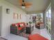 Relaxing screened-in patio featuring comfortable wicker furniture and a ceiling fan for outdoor enjoyment at 3057 Saint Thomas Ln, The Villages, FL 32162