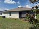 Backyard with a screened patio and landscaped flower beds at 3260 Casa Del Rey Ave, Kissimmee, FL 34746