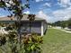 Landscaped backyard with a screened patio and mature trees at 3260 Casa Del Rey Ave, Kissimmee, FL 34746
