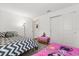 A cozy bedroom features two beds, a window, and neutral walls at 3260 Casa Del Rey Ave, Kissimmee, FL 34746