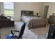 Well-lit bedroom featuring a comfortable bed, cozy seating, and neutral tones at 3260 Casa Del Rey Ave, Kissimmee, FL 34746