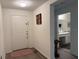 Clean entryway with a white front door and adjacent bathroom featuring a granite vanity at 3260 Casa Del Rey Ave, Kissimmee, FL 34746