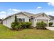 An inviting single-story home with a two-car garage and beautifully landscaped front yard at 3260 Casa Del Rey Ave, Kissimmee, FL 34746