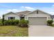 Charming single-story home with well-manicured landscaping and neutral color palette at 3260 Casa Del Rey Ave, Kissimmee, FL 34746