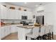 Modern kitchen featuring white cabinets, granite countertops, and stainless steel appliances at 3260 Casa Del Rey Ave, Kissimmee, FL 34746