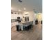Well-lit kitchen with granite counters, an island with bar seating, and white cabinetry at 3260 Casa Del Rey Ave, Kissimmee, FL 34746