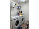 Functional laundry room with white appliances, shelving, and plenty of room for storage at 3260 Casa Del Rey Ave, Kissimmee, FL 34746