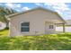 Home exterior showing a well-maintained lawn, sliding door, and a covered patio, perfect for outdoor activities at 33234 Kaylee Way, Leesburg, FL 34788