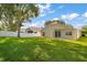 Expansive backyard with lush green grass, a privacy fence, and patio, offering ample space for recreation at 33234 Kaylee Way, Leesburg, FL 34788