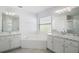 Bathroom features a soaking tub, dual sinks, and modern fixtures, providing a spa-like experience at 33234 Kaylee Way, Leesburg, FL 34788