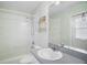 Well-lit bathroom with a shower-tub combo and a large mirror over the sink and toilet at 33234 Kaylee Way, Leesburg, FL 34788