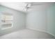 Neutral bedroom with a ceiling fan and a window, offering a calm and inviting space at 33234 Kaylee Way, Leesburg, FL 34788