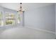 Open dining room with large windows, and a decorative light fixture that offers natural light at 33234 Kaylee Way, Leesburg, FL 34788