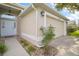 Home exterior showing a well-maintained lawn, a two car garage, and beautiful landscaping at 33234 Kaylee Way, Leesburg, FL 34788